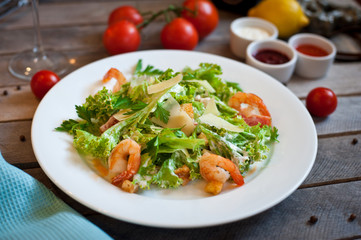 salad caesar with shrimps on white plate