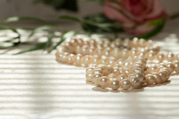 Still life of natural pearls with flowers.