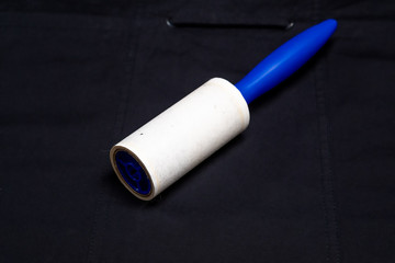 Adhesive roller for cleaning cloth on a black cloth
