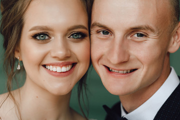 Close-up portrait of a man and a woman nearby. Close-up portrait of people. Bride and groom close to each other.