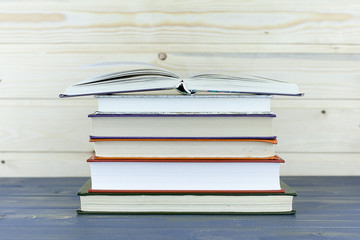 Old books on a wooden shelf. No labels,
