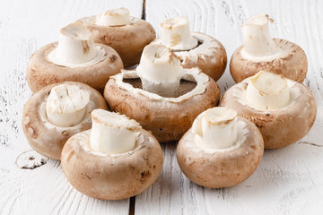 Edible mushrooms champignon on wooden table