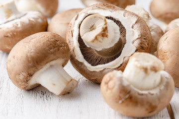 Edible mushrooms champignon on wooden table