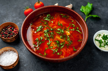 Borscht - Traditional Ukrainian dish in a plate on a stone background