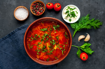 Borscht - Traditional Ukrainian dish in a plate on a stone background