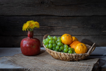 Still life from grape, bananas,orange and flowers