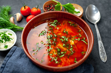 Borscht - Traditional Ukrainian dish in a plate on a stone background