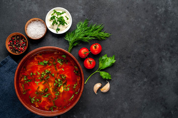 Borsch - Traditional Ukrainian dish in a plate on a stone background with copy space for your text