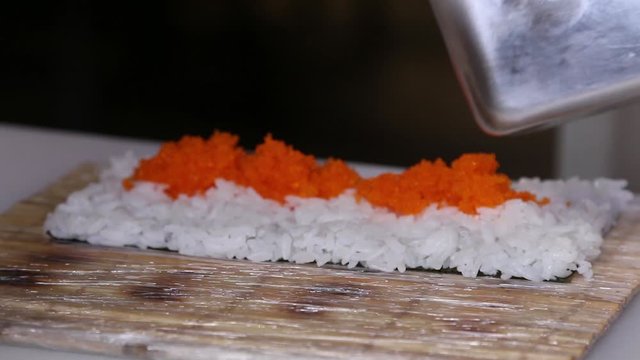 Chef's hands rolling a sushi roll. Sushi making process. Rolls the sushi roll	