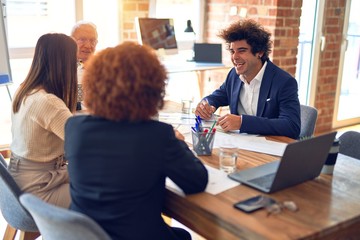 Group of business workers smiling happy and confident. Speaking with smile on face working together at the office.