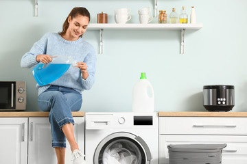 Young woman doing laundry at home