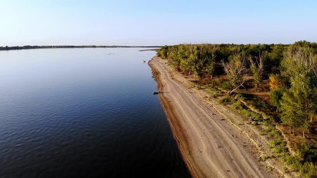 Flight over the beach, river, forest and fishermans