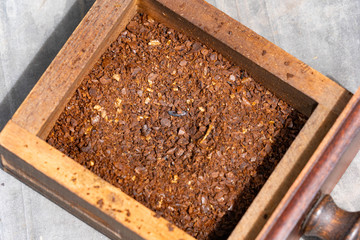 Grinded coffee beans are in a tray.