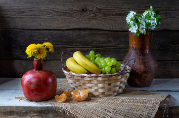 Still life from grape, bananas,orange and flowers