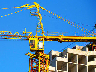 Tower crane and building activity. Construction site background.