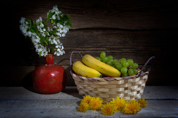 Still life from grape, bananas,orange and flowers