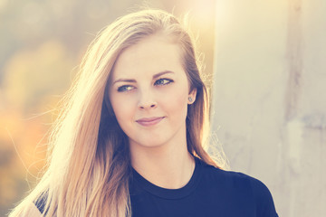 Portrait of beautiful long haired young girl looking at side.