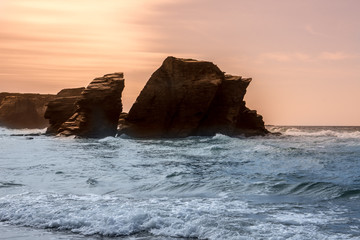 sunset lovely rock formation at praia de aguas santas beach