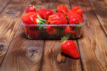 Ripe strawberries in a plastic container