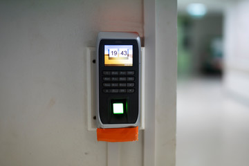 Fingerprint scanner on wall for unlock door security system, Fingerprint and password lock in a office building.