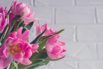 Spring flowers. Bouquet pink tulips on white wooden background.