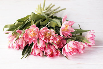 Beautiful bouquet delicate pink tulips on a white background. Holiday concept.