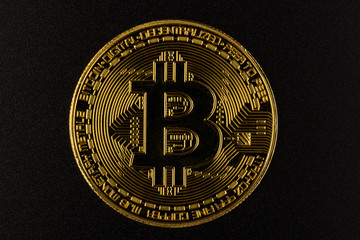 Gold bitcoin in on black backgroud. Business, money, cryptocurrency concept.