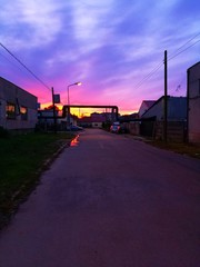 Fototapeta premium Industrial urban street in the evening light, with vintage warehouses and factories