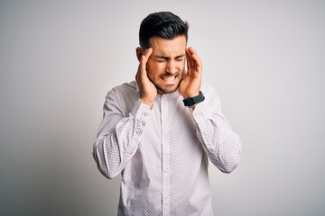 Young handsome man wearing elegant shirt standing over isolated white background with hand on headache because stress. Suffering migraine.