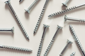 
Steel screws, metal screw, screws on a white background view from the top.