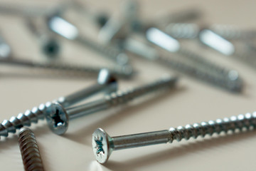 
Steel screws, metal screw, screws on a blurry background.