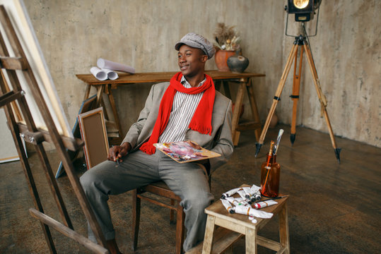 Fashionable Male Painter In Hat And Red Scarf