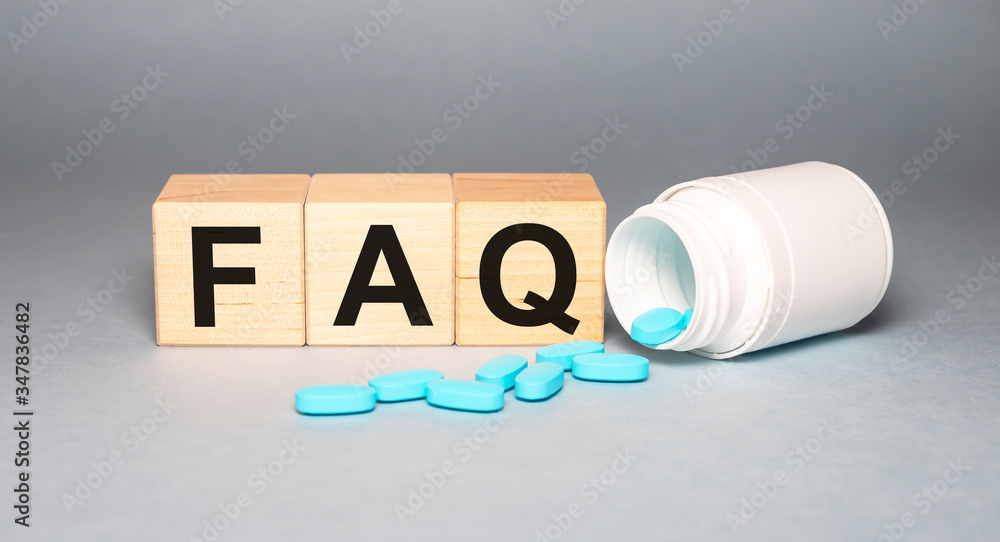 Poster wooden cube with faq text ( frequently asked questions) on grey table background with jar of pills. 