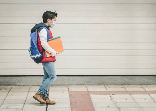 Covid-19,kid With Medical Mask And Backpack Going To School