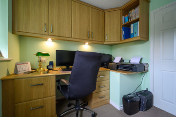 Home office or study, which is a converted bedroom, fitted with desk and cupboards