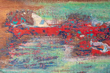 Texture of vintage wood boards with cracked paint of green, red, blue color