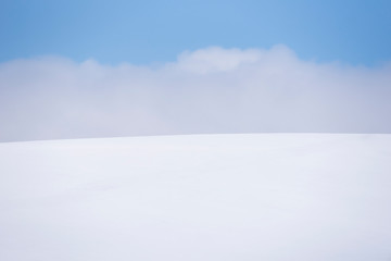 Fototapeta na wymiar Scenic landscape of Snow Hill at Biei Pathcwork Road in winter, Hokkaido, Japan