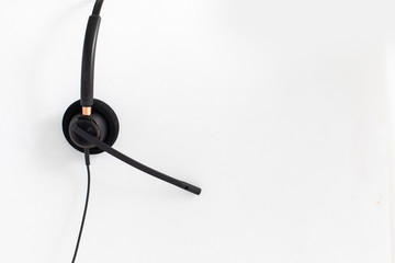 VOIP headset, pen and notebook on laptop computer keyboard. Communication support for callcenter and customer service Helpdesk. 