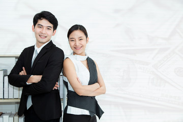 Young Successful business man and woman standing back to back with crossed hands against money market background. Partnership in business and Black&White fashion concept.