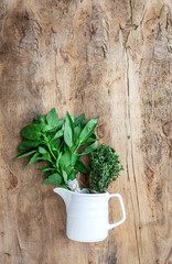 fresh aromatic herbs from above on old wood  background