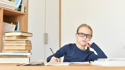 a child at home studying at a Desk