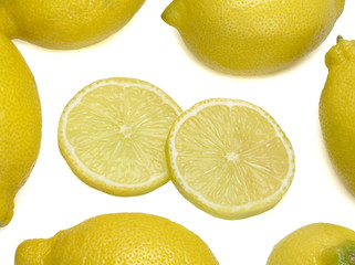 Yellow lemons and two their slices isolated on white background