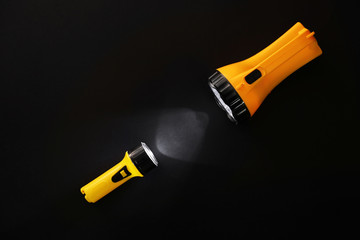 Modern flashlights on dark background
