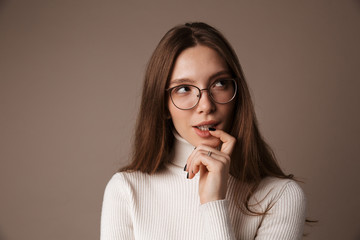 Photo of thinking beautiful woman posing and looking aside