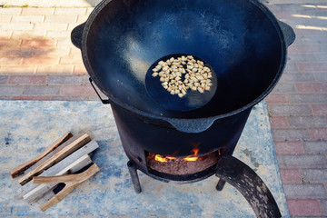 Roasting of mutton fat to a condition of crackers, some stage of preparation of a national Uzbek...