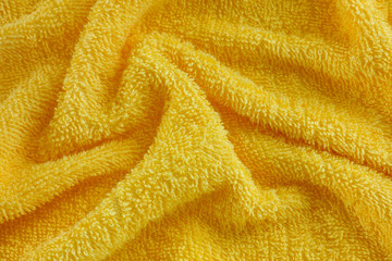 Fototapeta na wymiar Wrinkled yellow towel texture background