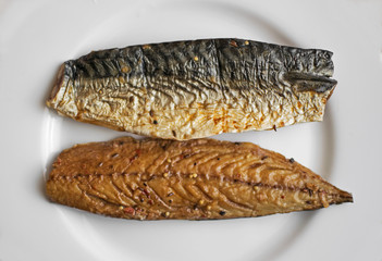 Smoked fish on a porcelain plate. Kipper. Mackerel