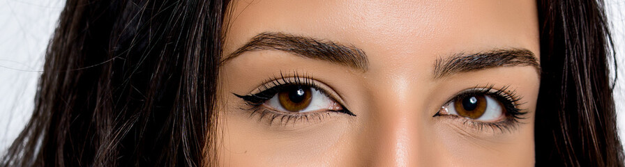 Fototapeta premium close-up photo of woman eye with eyeliner makeup on white background.