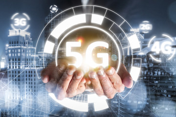 success businessman hold 5G technology evolution 4G, 3G, 2G, 1G, connection online network with high speed cyber access digital wireless for people communication business with cityscape view