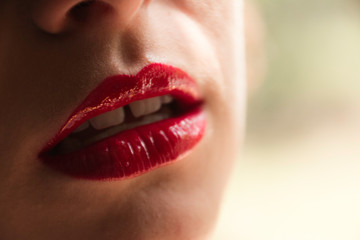 Fototapeta premium A young girl's red lips.